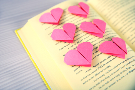 Heart bookmark for book on wooden table closeupの写真素材