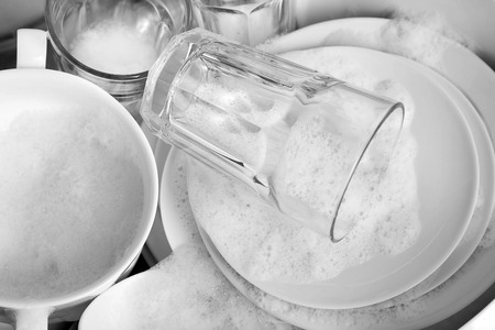 Pile of dishes in sink closeupの写真素材