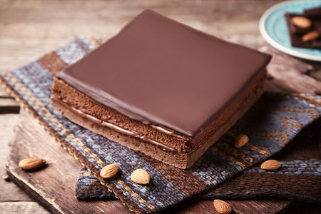 Delicious chocolate cake with coffee beans on wooden backgroundの写真素材