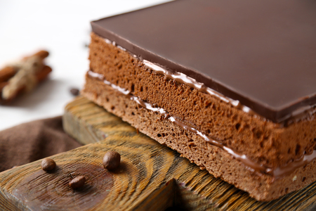Delicious chocolate cake on wooden cutting board closeupの写真素材