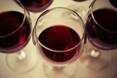 Glasses of red wine on white table closeupの写真素材