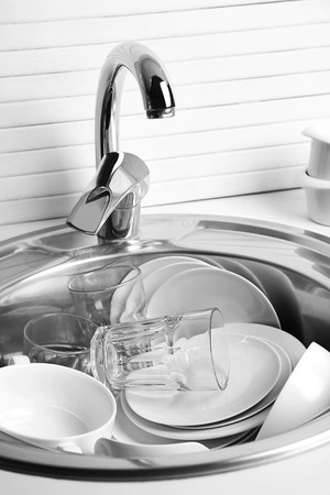 Pile of dishes in sink closeupの写真素材