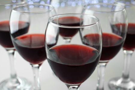 Glasses of red wine on white table closeupの写真素材