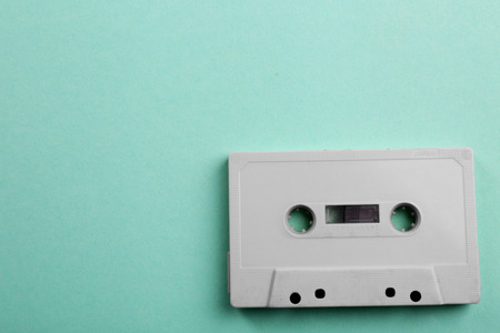 Old audio cassette on turquoise backgroundの写真素材