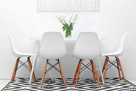 Modern dining room. White chairs and table with bouquet of flowers, abstract picture on the wallの写真素材