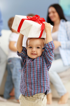 Cute baby with gift box in the roomの写真素材