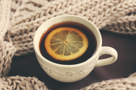 Cup of tea and woolen scarf, closeup