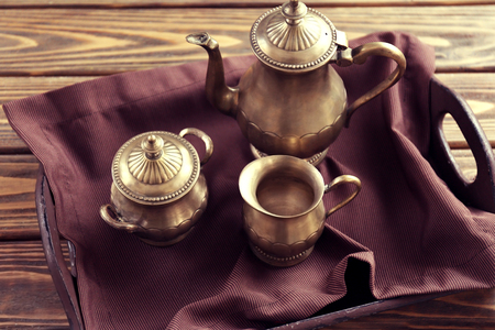 Old tea set on the tray on wooden background, closeupの写真素材