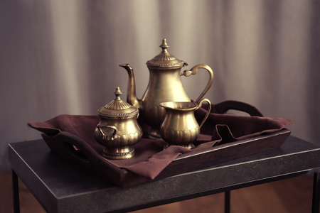 Old tea set on the tray on wooden tableの写真素材
