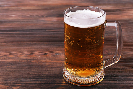 Glass of beer on wooden backgroundの写真素材