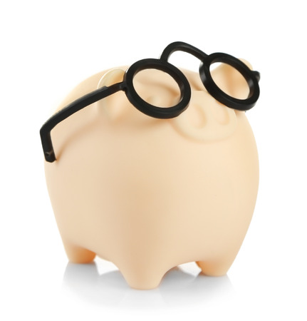 Piggy bank in glasses isolated on whiteの写真素材