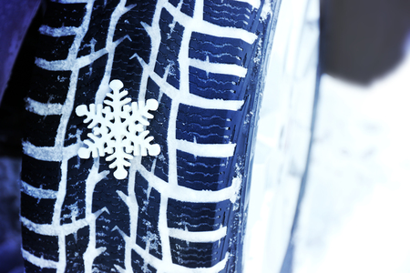 Winter tires in snow with snowflake, closeupの写真素材