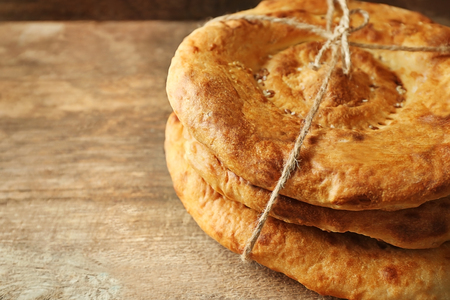 Fresh fried bread on wooden background