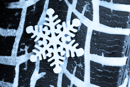 Winter tires in snow with snowflake, macro viewの写真素材