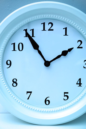 Clock face in blue light closeup