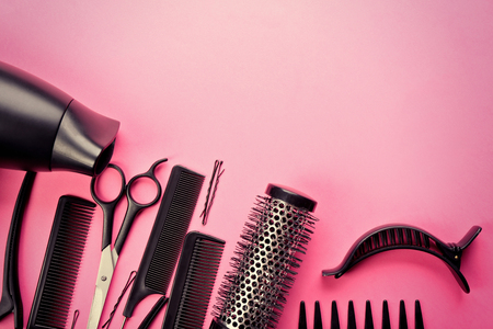 Hairdresser set with various accessories on pink backgroundの写真素材