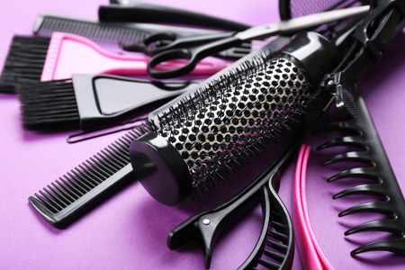 Hairdresser set with various accessories on violet backgroundの写真素材