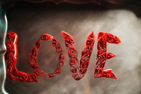 Red quilling word love on a glassの写真素材