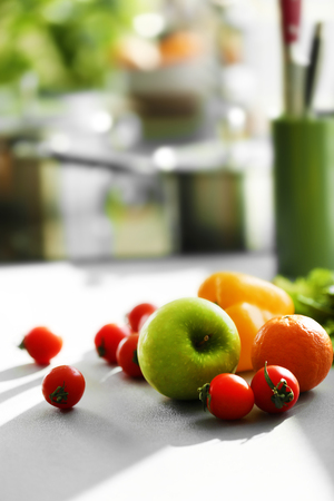Fresh fruits and vegetables on white kitchen table, close upの写真素材