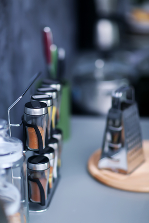 Spices with metal grater on modern kitchen table, close upの写真素材