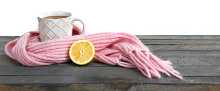 Beautiful winter composition with cup of hot drink, on wooden table with white background