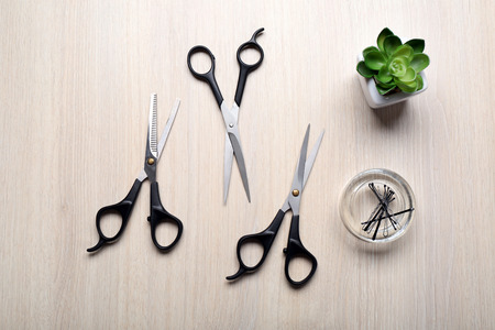 Barber set with tools on light wooden table