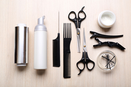 Barber set with tools and cosmetic on light wooden tableの写真素材