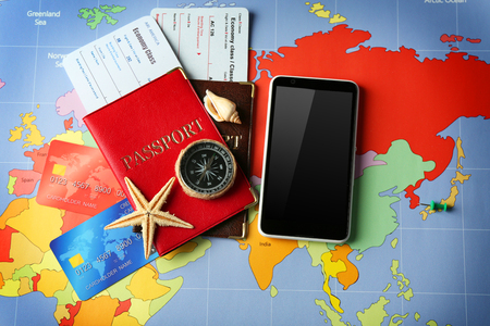 Credit cards with passports and tickets for vacations on the world map backgroundの写真素材