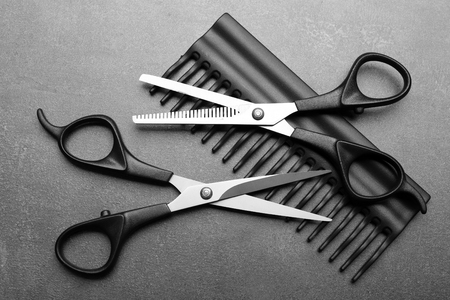 Barber set with comb and scissors on grey background, close upの写真素材