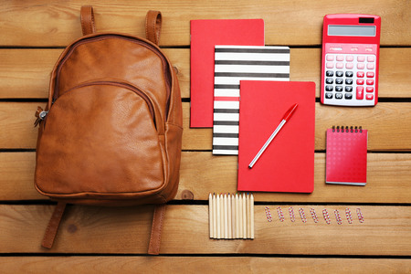 School set with backpack, shoes and supplies on wooden backgroundの写真素材