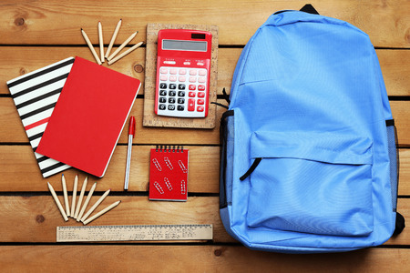 School set with backpack, shoes and supplies on wooden backgroundの写真素材
