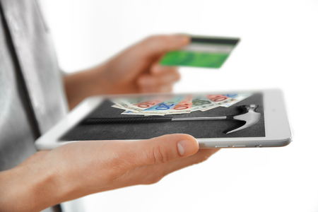 Female hands with digital tablet and credit card, closeupの写真素材