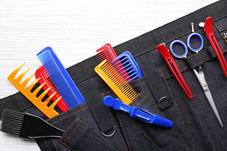 Professional hairdressing equipment in black case on white table backgroundの写真素材