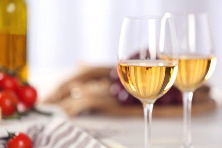 Glasses of red wine with food on table closeupの写真素材