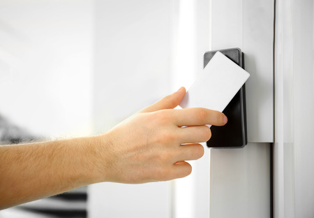 Security alarm keypad with male hand and card, closeupの写真素材