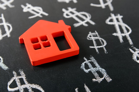 House figure and painted dollar symbols on chalkboard,closeupの写真素材