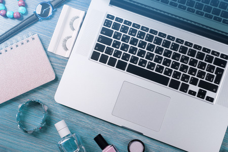 Laptop and female accessories on wooden table, top viewの写真素材
