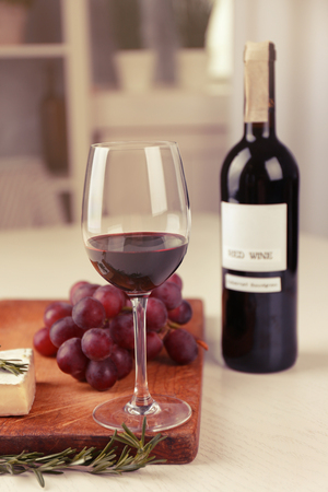 Glass of wine with food on table indoorsの写真素材