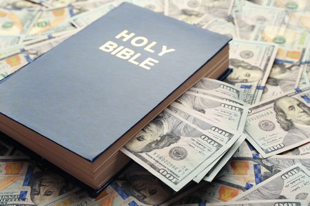 Holy Bible on money background, closeup