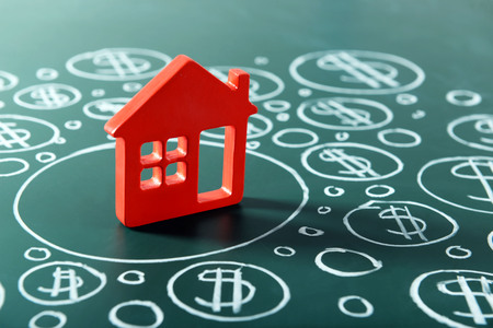 House figure and painted dollar symbols on chalkboard,closeupの写真素材