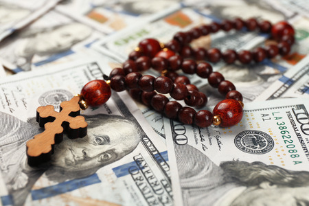 Rosary beads on money background, closeupの写真素材