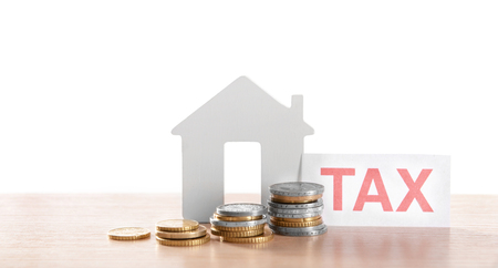 House figure, coins and tax sign, closeupの写真素材