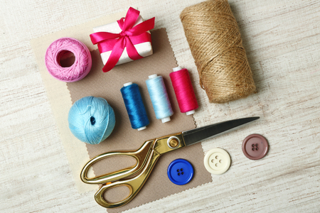 Sewing creative accessories on wooden table, top viewの写真素材
