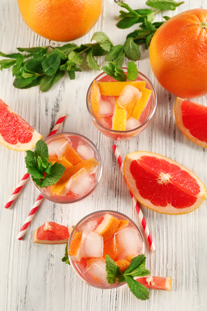 Ripe grapefruits and fresh juice with mint, close upの写真素材