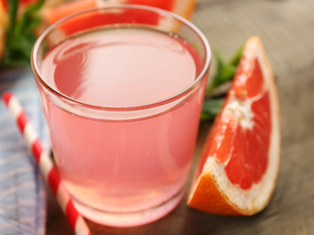 Ripe grapefruits and fresh juice with mint, close upの写真素材