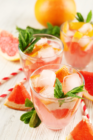 Ripe grapefruits and fresh juice with mint, close upの写真素材