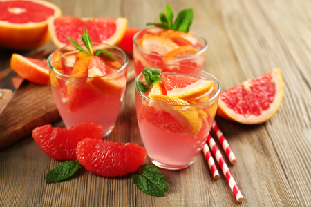 Ripe grapefruits and fresh juice with mint, close upの写真素材