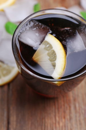 Glass of cola with cubes of ice and lemon , closeupの写真素材