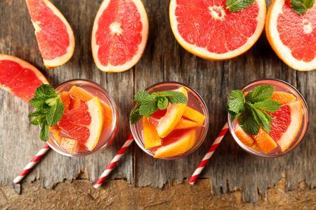 Ripe grapefruits and fresh juice with mint, close upの写真素材