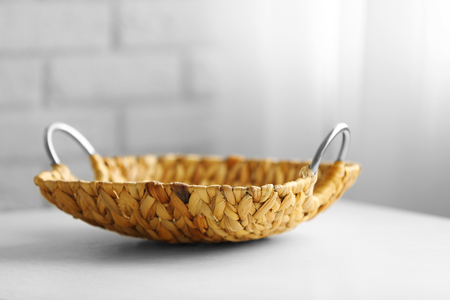 Wicker salver with metal handles on wooden table background, closeupの写真素材